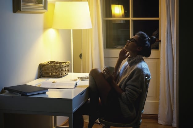 A student is sitting at a desk in a dimly lit room, looking stressed while working on a laptop. Overlaid on the image is a transparent graphic showing the rising costs of tuition and fees at American universities. This visualization highlights the financial burden faced by many students seeking higher education.