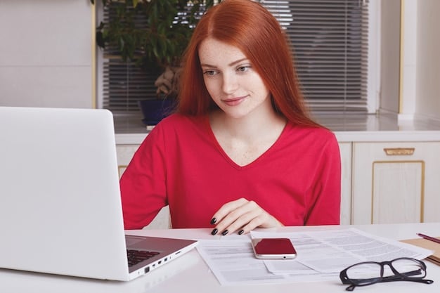 A person sitting at a desk, reviewing documents related to student loans on a laptop. The scene is lit with natural light, creating a calm and focused atmosphere. The person appears to be carefully analyzing their financial situation.