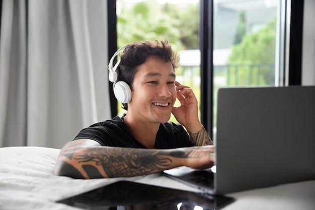 A person wearing headphones and speaking into a microphone, participating in an online language exchange with someone on a video call, in a home setting.