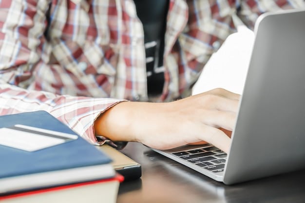 A close-up shot of a student's hands typing on a laptop, with college textbooks and a notebook in the background. The lighting is warm, creating a focused and studious atmosphere. This image demonstrates the integration of technology and traditional learning.