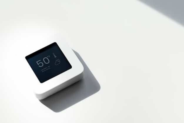 A close-up of a Nest smart thermostat mounted on a wall, showcasing its sleek design and digital display. The thermostat is set to a comfortable temperature, with an energy-saving leaf icon indicating efficient operation.