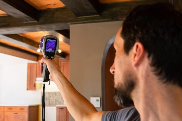 A technician using a thermal imaging camera to detect heat loss around a window frame in a home. The image highlights energy inefficiencies.