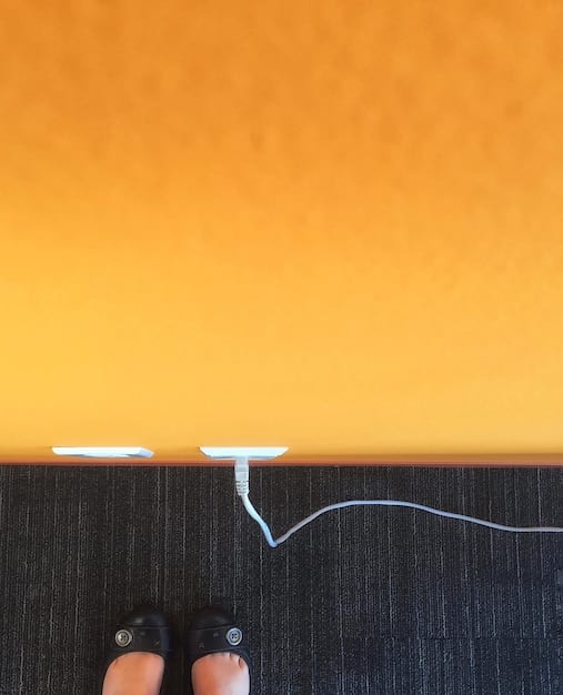 A close-up shot of a smart plug being plugged into a wall outlet with a lamp connected. The focus should be on the plug itself, showcasing its design and indicating its ease of installation. Include a smartphone in the background to symbolize remote control capability.