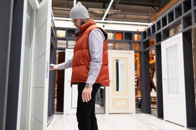 A person installing a Door/Window sensor on a white window frame, with the security system box and tools neatly arranged on a nearby table.