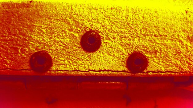 A close-up of a malfunctioning furnace with visible rust and soot. A carbon monoxide detector is mounted nearby, showing an elevated CO level.
