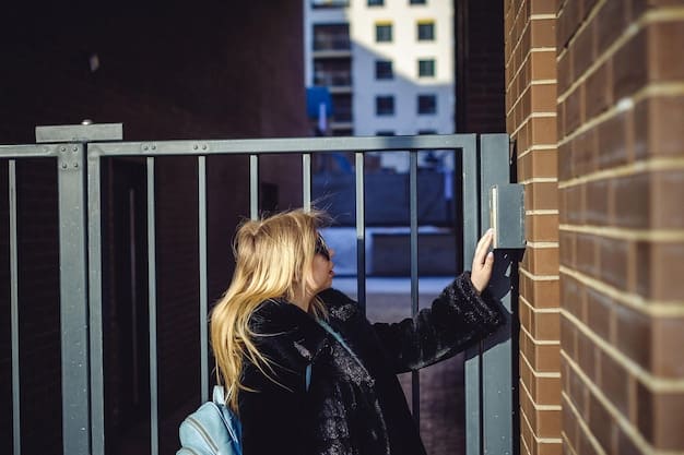 A person installing a video doorbell on their front door, focused on the security camera aspect.